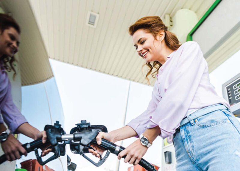 Woman fueling up vehicle