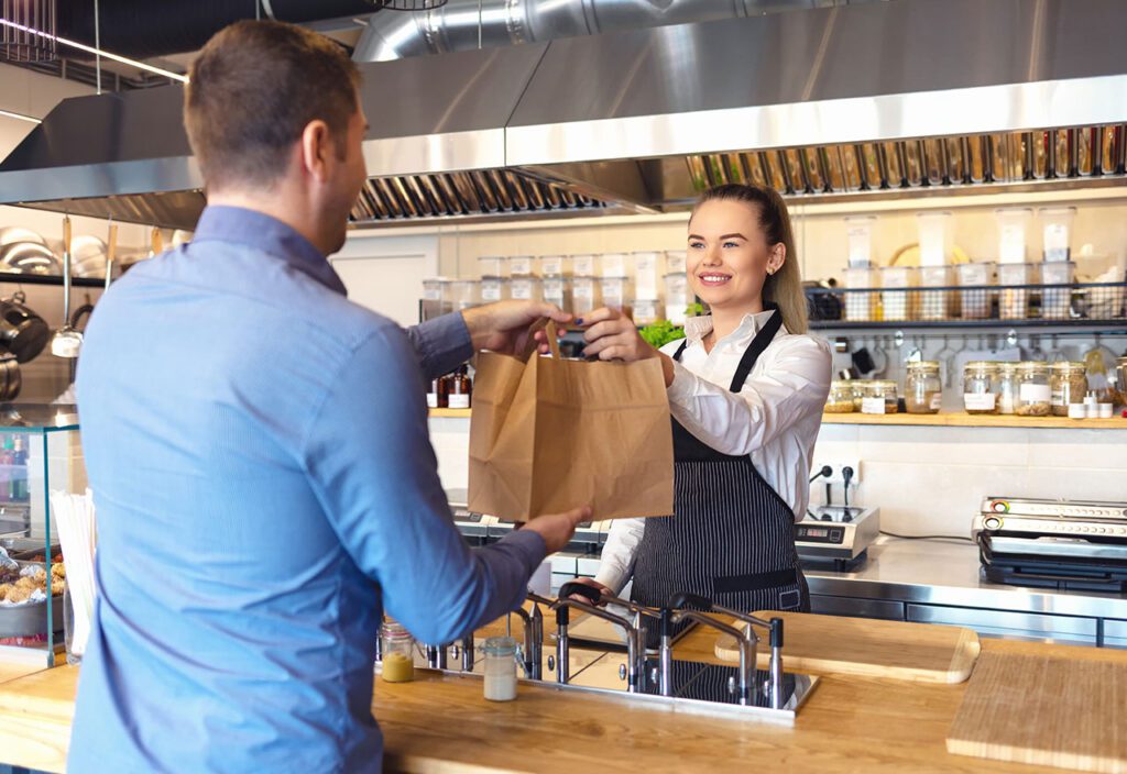 Self-service desk with touch screen in fast food restaurant 